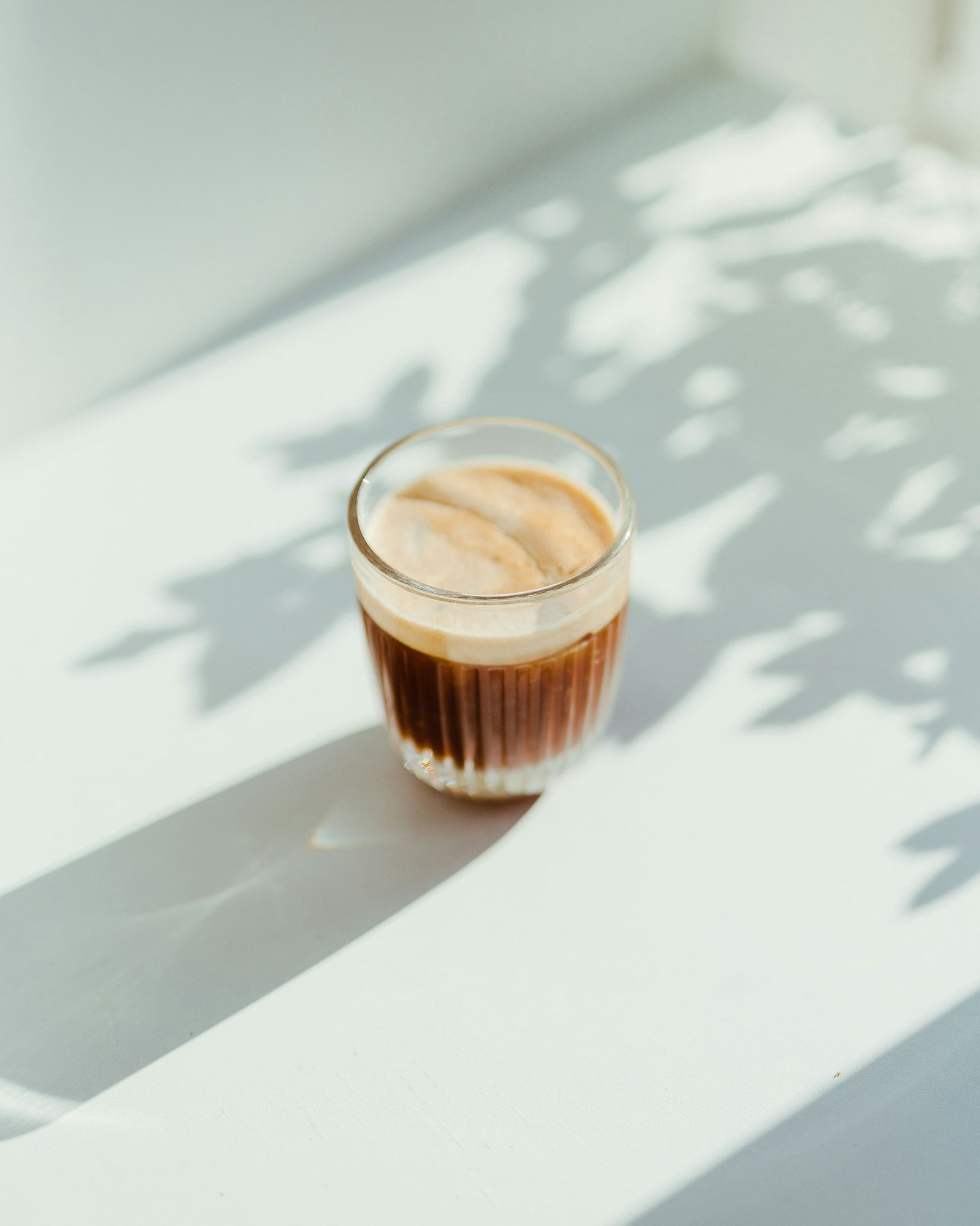 Iced latte in a glass in sunlight