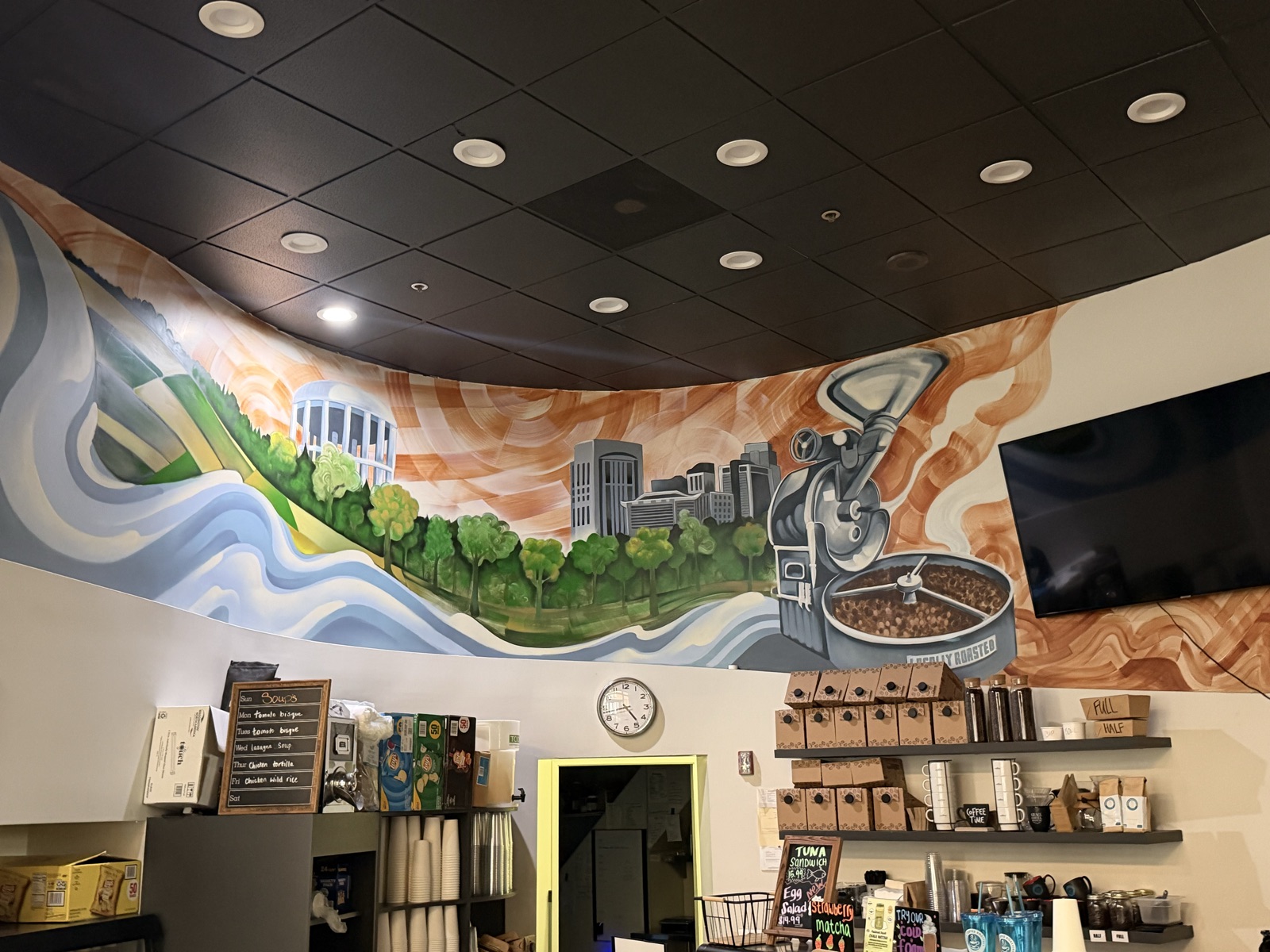 Mural of the Sacramento skyline and a coffee roaster above the Grace Coffee Roasters counter